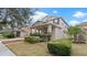 Charming two-story home with landscaped yard and inviting front porch, offering curb appeal at 11412 Chateaubriand Ave, Orlando, FL 32836