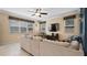 Living area with sectional sofa, ceiling fan, and lots of natural light at 11412 Chateaubriand Ave, Orlando, FL 32836