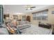 Bright living room with sectional sofa, large TV, and ceiling fan at 11412 Chateaubriand Ave, Orlando, FL 32836