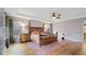 Relaxing main bedroom with a bamboo bed frame and colorful rug at 11412 Chateaubriand Ave, Orlando, FL 32836