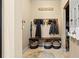 Organized mudroom with bench, hooks, and storage baskets at 11412 Chateaubriand Ave, Orlando, FL 32836