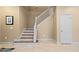 Modern staircase with light wood steps and white railing at 11412 Chateaubriand Ave, Orlando, FL 32836