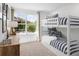 Charming bedroom with bunk beds, large window view, and a cozy, playful atmosphere at 1273 Coral Bean Ln, Winter Springs, FL 32708