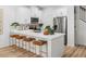 Modern kitchen featuring white cabinets, stainless steel appliances, and a spacious center island with seating at 1273 Coral Bean Ln, Winter Springs, FL 32708