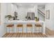 Contemporary kitchen boasting a large quartz island with bar stools, stainless appliances, and minimalist design at 1273 Coral Bean Ln, Winter Springs, FL 32708