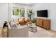 Inviting living room with a comfortable sofa, chairs, and a large window offering scenic views at 1273 Coral Bean Ln, Winter Springs, FL 32708