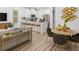 Bright open-concept living area with a kitchen island, dining table, and contemporary furnishings at 1273 Coral Bean Ln, Winter Springs, FL 32708