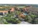 Aerial shot showcases residences, a pool, and a golf course amidst green surroundings at 1375 Tuscana Ln # 1107, Davenport, FL 33896