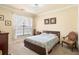 Comfortable bedroom with carpet floors, a queen sized bed, and natural light at 1375 Tuscana Ln # 1107, Davenport, FL 33896