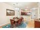 Inviting dining area with a wooden table and chairs illuminated by a modern chandelier, open to a kitchen at 1375 Tuscana Ln # 1107, Davenport, FL 33896