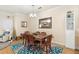 Dining room featuring a wooden table, chairs, a chandelier, and an accent rug at 1375 Tuscana Ln # 1107, Davenport, FL 33896