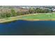 Scenic view of the golf course with a tranquil lake and lush greenery at 1375 Tuscana Ln # 1107, Davenport, FL 33896