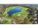 Aerial view of the community golf course with lush greens and a large pond at 1375 Tuscana Ln # 1107, Davenport, FL 33896