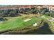 Beautiful golf course featuring manicured greens and white sand bunkers near a tranquil lake at 1375 Tuscana Ln # 1107, Davenport, FL 33896