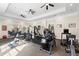 Well-equipped community gym featuring various exercise machines, mirrors, and ceiling fans at 1375 Tuscana Ln # 1107, Davenport, FL 33896