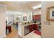 Open-concept kitchen featuring granite countertops, wood cabinets, and stainless steel appliances at 1375 Tuscana Ln # 1107, Davenport, FL 33896