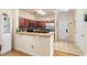 Modern kitchen featuring stainless steel appliances, wood cabinets, and a breakfast bar at 1375 Tuscana Ln # 1107, Davenport, FL 33896