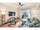 Comfortable living room with a modern ceiling fan, large tv, and sun-filled sliding doors at 1375 Tuscana Ln # 1107, Davenport, FL 33896