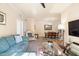 Welcoming living room with a plush sofa, glass coffee table, and view to the dining area at 1375 Tuscana Ln # 1107, Davenport, FL 33896
