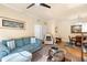 Cozy living room with a plush sofa, glass coffee table, and adjacent dining room at 1375 Tuscana Ln # 1107, Davenport, FL 33896
