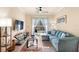 Bright living room features a ceiling fan, glass table, and sliding doors to the outside at 1375 Tuscana Ln # 1107, Davenport, FL 33896