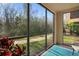 Bright sunlit screened-in porch overlooking a garden and a brick path at 1375 Tuscana Ln # 1107, Davenport, FL 33896
