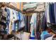 Organized walk-in closet filled with hanging clothes, folded items, shoes, and storage boxes at 1375 Tuscana Ln # 1107, Davenport, FL 33896