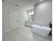 Bathroom with soaking tub, standalone shower, white vanity and tile flooring at 150 Marion Oakes Trl, Ocala, FL 34473