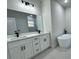 Stylish bathroom featuring double sinks, granite countertops, and a modern soaking tub at 150 Marion Oakes Trl, Ocala, FL 34473