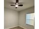 Cozy bedroom featuring a ceiling fan, window with blind, and light-colored walls at 150 Marion Oakes Trl, Ocala, FL 34473