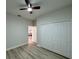Neutral bedroom with closet, ceiling fan, light walls, and view into hallway at 150 Marion Oakes Trl, Ocala, FL 34473
