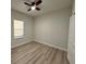 Bright bedroom features a ceiling fan, window with blind, and light-colored walls at 150 Marion Oakes Trl, Ocala, FL 34473