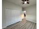 Neutral bedroom with closet, ceiling fan, light walls, and view into hallway at 150 Marion Oakes Trl, Ocala, FL 34473