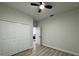 Neutral bedroom with closet, ceiling fan, light walls, and view into hallway at 150 Marion Oakes Trl, Ocala, FL 34473