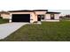 Modern home featuring a black garage door and a well-manicured lawn at 150 Marion Oakes Trl, Ocala, FL 34473