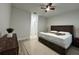Main bedroom with light wood floors, ceiling fan, and view of hallway at 150 Marion Oakes Trl, Ocala, FL 34473