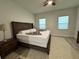 Main bedroom featuring a large bed, ceiling fan, and natural light at 150 Marion Oakes Trl, Ocala, FL 34473