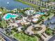 An aerial view of the community amenities featuring a splash pad, playground, clubhouse and multiple swimming pools at 1505 Mumbai Way, Kissimmee, FL 34747