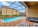 Screened pool and patio with seating area at 1505 Mumbai Way, Kissimmee, FL 34747