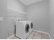 Bright laundry room features a washer and dryer at 15157 Sunrise Grove Ct, Winter Garden, FL 34787