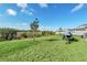 Spacious backyard with green grass and a jet ski on trailer at 157 Pineywoods St, St Cloud, FL 34769