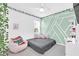 Bright bedroom with a unique wall design and comfy seating at 157 Pineywoods St, St Cloud, FL 34769