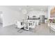 Open concept dining room with glass table and chairs, adjacent to kitchen at 157 Pineywoods St, St Cloud, FL 34769