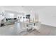Open concept dining room with glass-top table and white chairs at 157 Pineywoods St, St Cloud, FL 34769