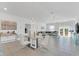 Bright dining room features a glass table with white chairs, and an open concept view to the living room at 157 Pineywoods St, St Cloud, FL 34769