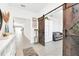 Bright entryway with a rustic barn door leading to living room at 157 Pineywoods St, St Cloud, FL 34769