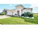 Two-story home with a two-car garage and landscaped front yard at 157 Pineywoods St, St Cloud, FL 34769