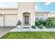 Front entrance with arched entryway and manicured landscaping at 157 Pineywoods St, St Cloud, FL 34769