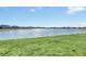 Scenic community lake with grassy shoreline at 157 Pineywoods St, St Cloud, FL 34769