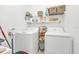 Convenient laundry room with washer, dryer, and shelving at 157 Pineywoods St, St Cloud, FL 34769